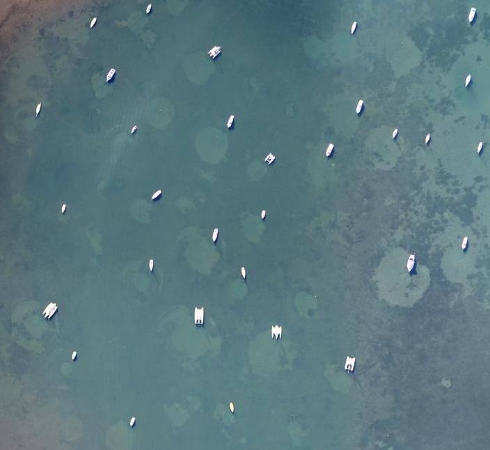 Aerial photo of "crop circles" resulting from raking of sea floor vegetation and marine habitat. Remedied by use of StormSoft elastic mooring rodes.